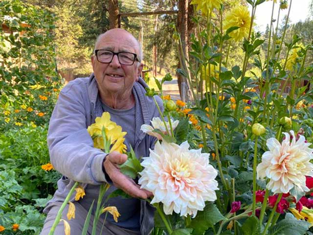 Chris Kroupa showing off the dahlias in his garden